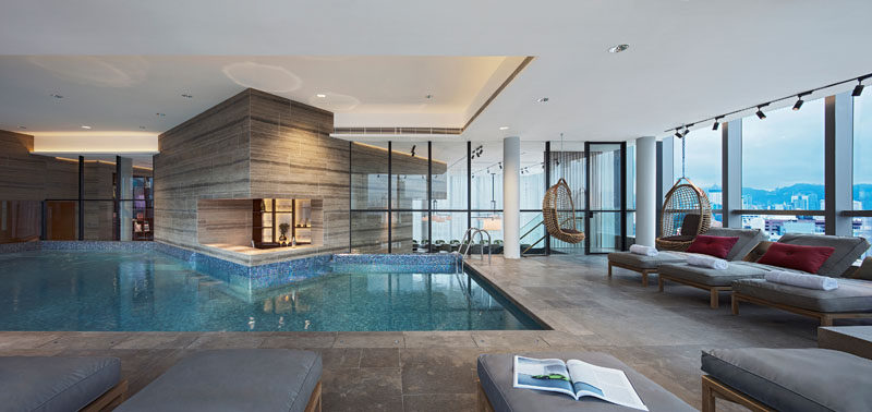 The modern clubhouse has an indoor swimming pool and lounging area with picturesque views of Hong Kong.