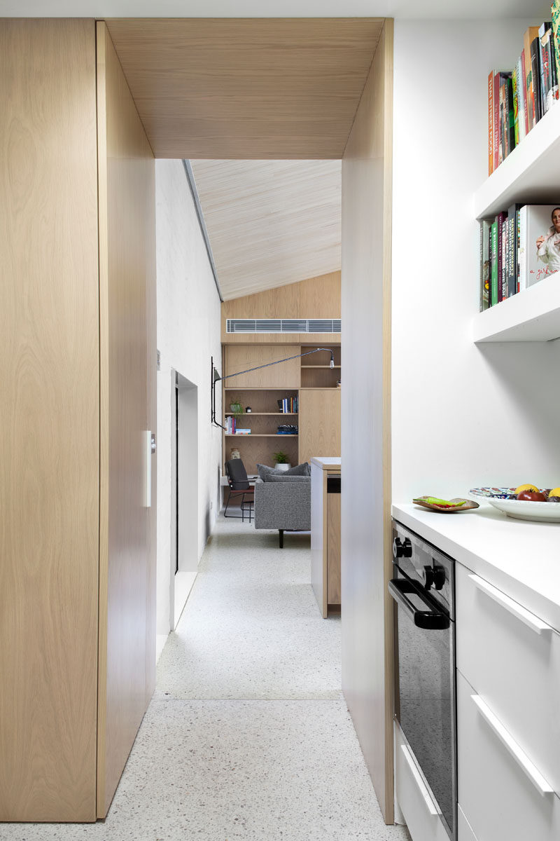 This modern pantry has plenty of additional storage with cabinets, drawers and open shelving.