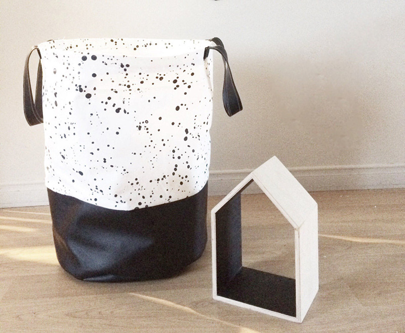 Made with 100% cotton fabric and faux leather, this funky black and white speckled laundry hamper is perfect in any room.