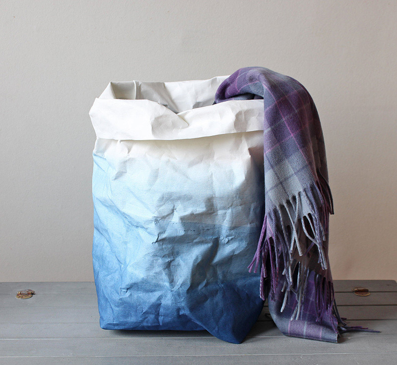 This modern laundry basket is a washable paper basket made from natural cellulose fibres, and dyed in shades of white and indigo. 