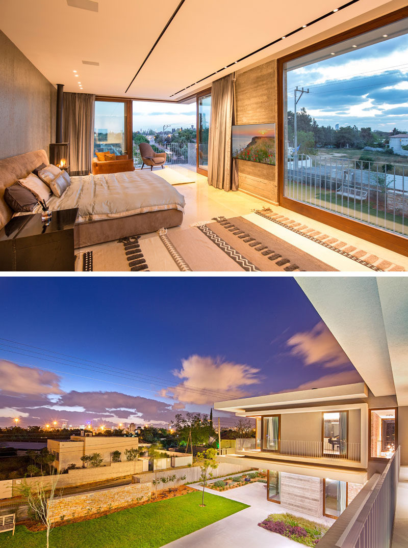 This modern master bedroom has a large picture window as well as sliding doors that meet at the corner. The wood framed glass doors can be opened to provide access to a balcony and allow for the breeze to flow into the room.