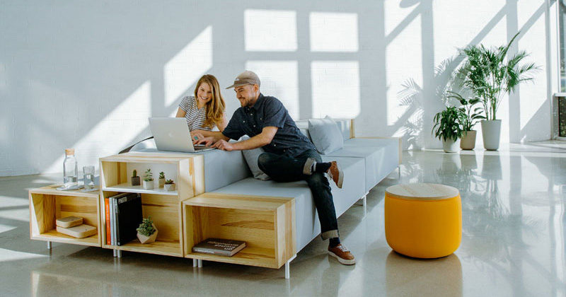 Designer Trevor Hoiland has created The Story Collection, a modern and modular office furniture series that's made with a wood storage cubby at the end of the seats, coffee tables and benches.