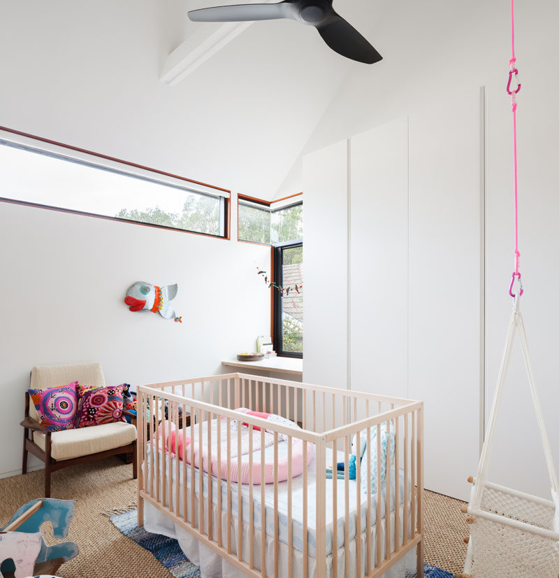 This mostly white nursery has clerestory windows that allow natural light to fill the room without it being too bright.