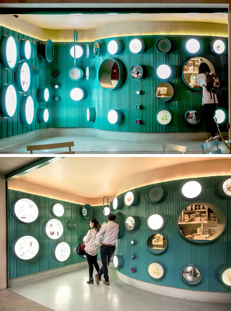 At night, this modern ice cream shop has hidden lighting above the ribbed metal, and lit circles to highlight the menu and draw customers inside.