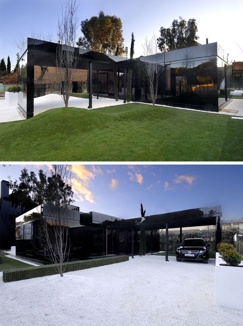 Shiny black material makes up the exterior of this modern modular home. #ModernBlackHouse #BlackHouse #BlackExterior #BlackArchitecture