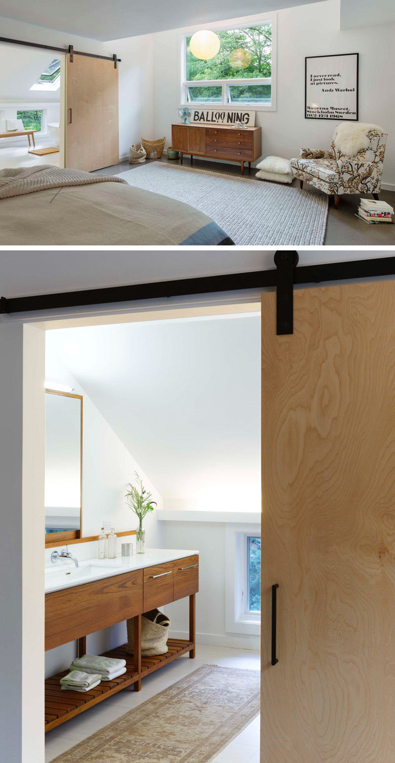 This light wood sliding barn door leads from the bedroom into the bright ensuite bathroom.