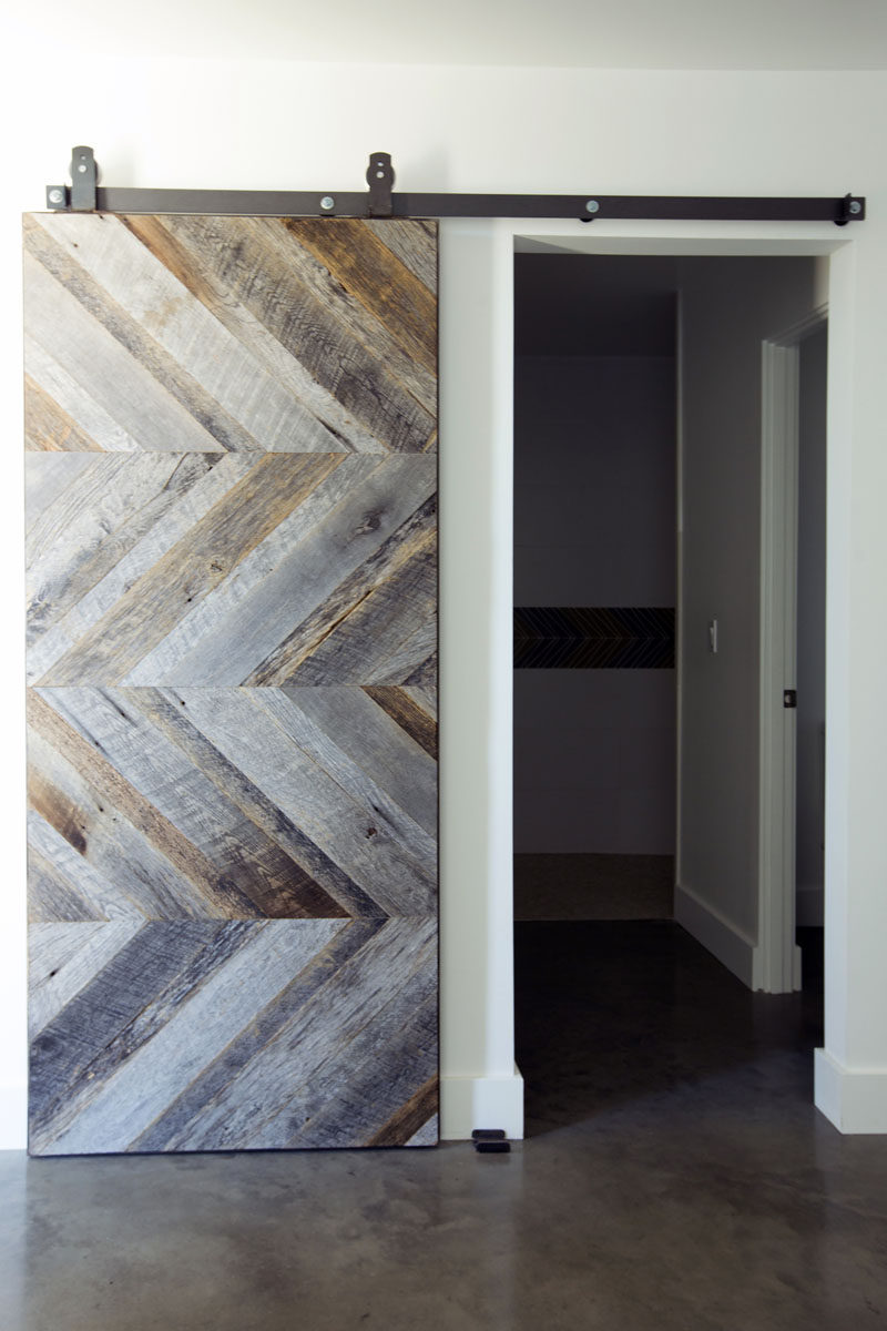 Wood panels arranged in a chevron pattern give this sliding barn door a modern appearance while also maintaining a rustic, industrial look as well.