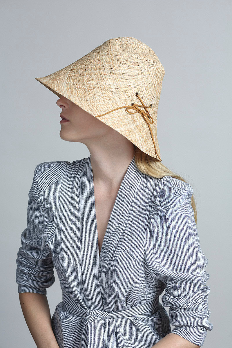 Yael Cohen, a fashion designer based in Israel, has created a line of modern straw hats that are perfect for summer, like this modern light colored straw bucket hat that has a lace detail on it. 