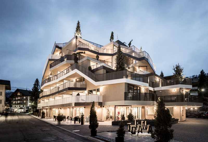 noa* have redesigned Hotel Tofana in Italy, with terraces and balconies are lined with coniferous trees and plants, which are connected by vertical ramps and stairs, creating an illusion of a summit for the hotel. 