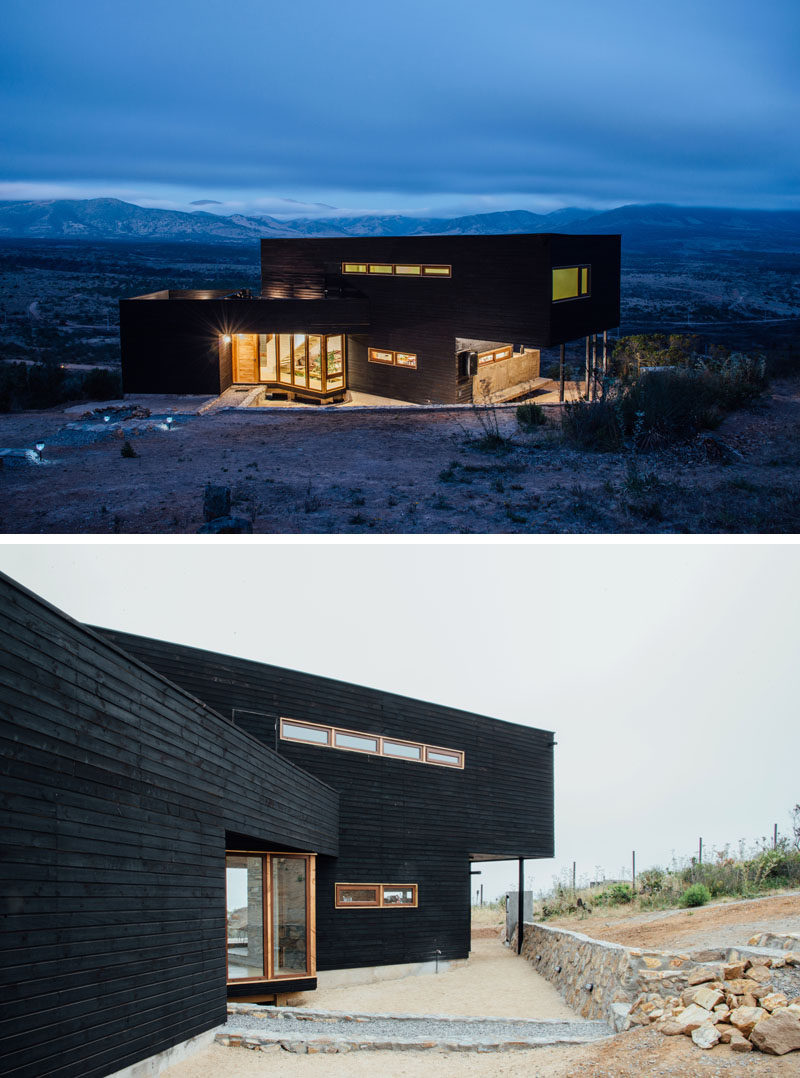 This modern black house has burnt wood siding (shou sugi ban), while lighter wood frames the windows and doors.