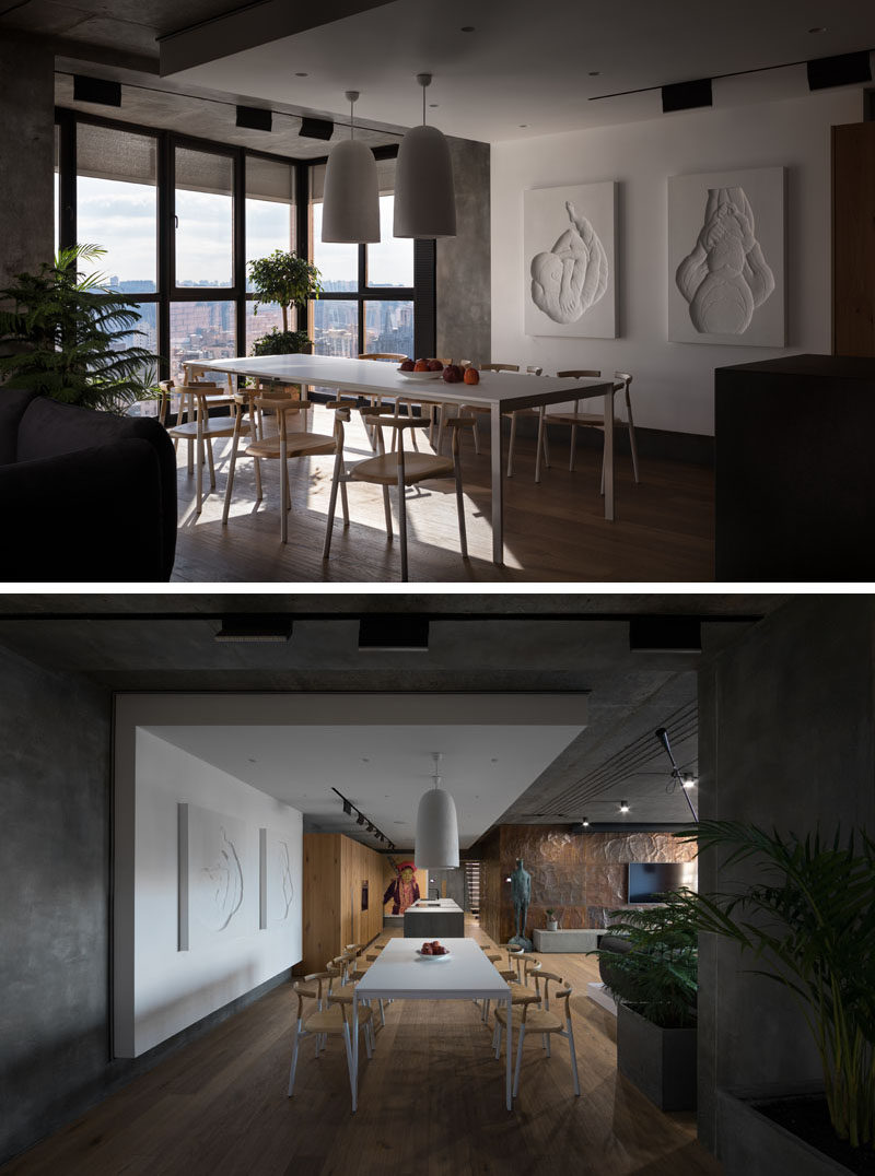 In this modern dining room, the simplistic dining set compliments the wood flooring and accents found throughout the rest of the home. By locating the dining room beside the windows, natural light fills the room and provides a view of the city while enjoying a meal. 