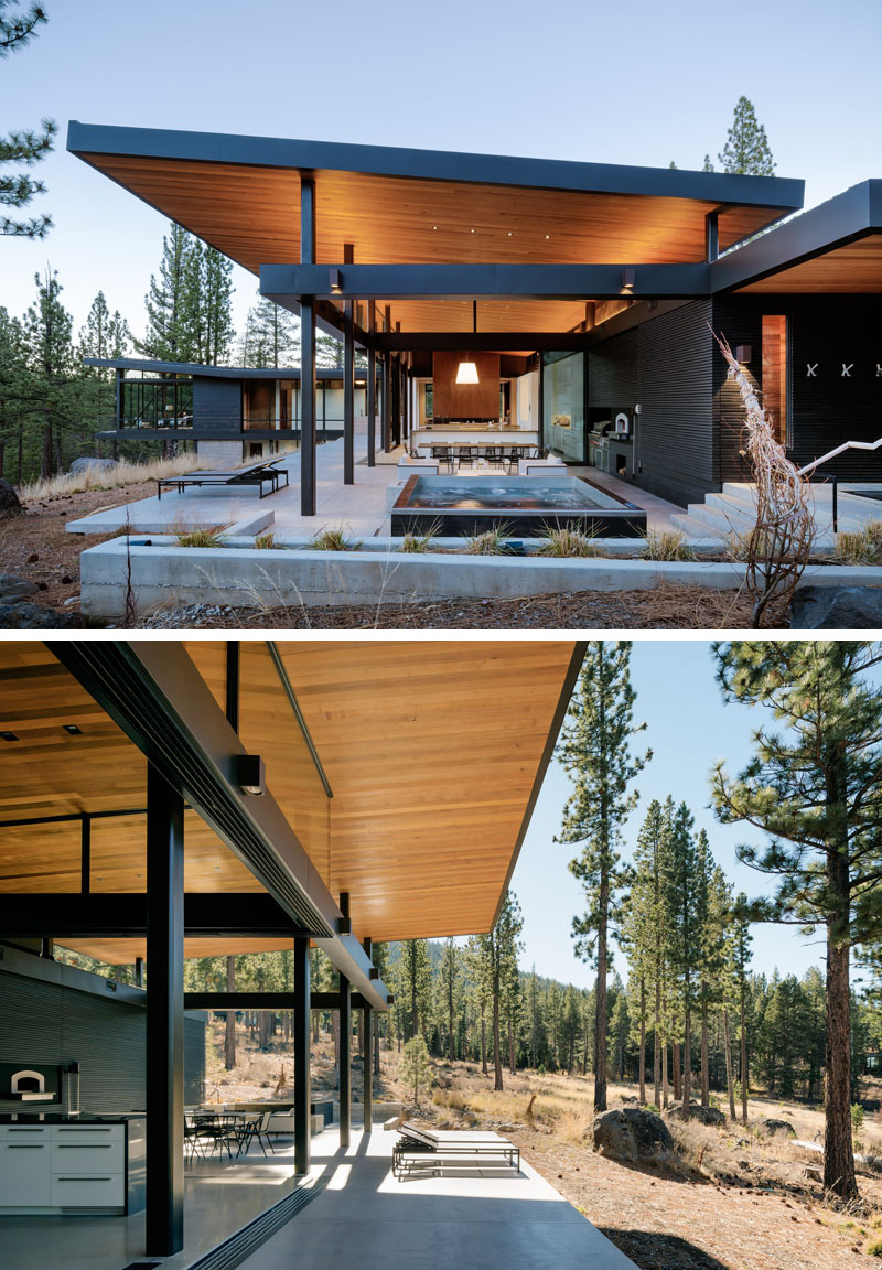 The main floor of this modern house opens up to an outdoor area with hot tub, surrounded by a concrete patio with multiple seating arrangements, making this space a great spot to lounge and enjoy the outdoors.