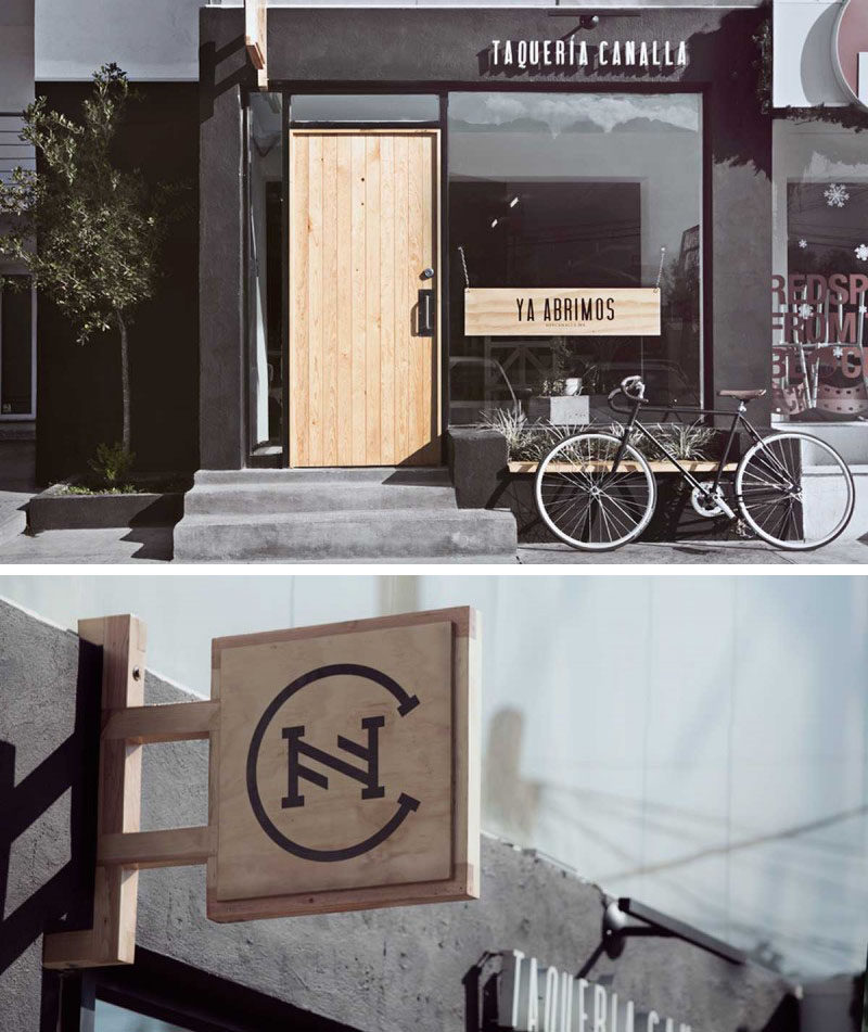 The light wood signs on the exterior of this taqueria make the dark letters and logo stand out so that passersby can easily make out the name of the restaurant.