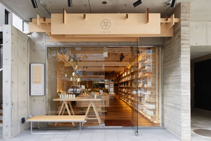 The wood sign with its small simple logo above this tea shop in Japan looks clean and natural against the concrete building it's attached to.