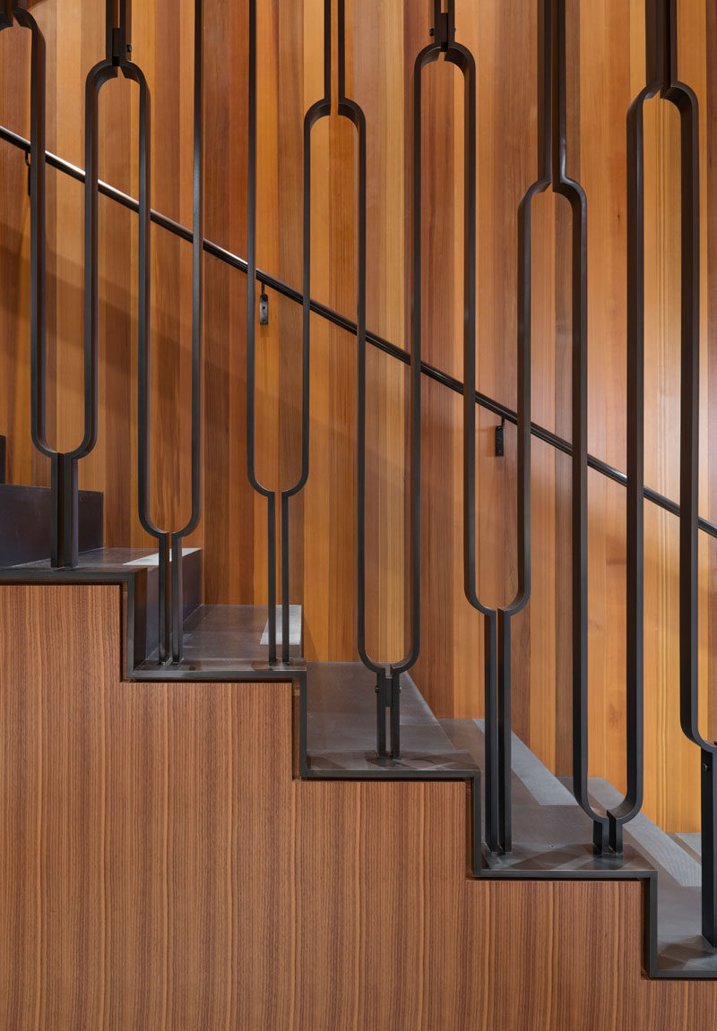 These wood and steel stairs have a decorative handrail that leads up to the front door and master bedroom.