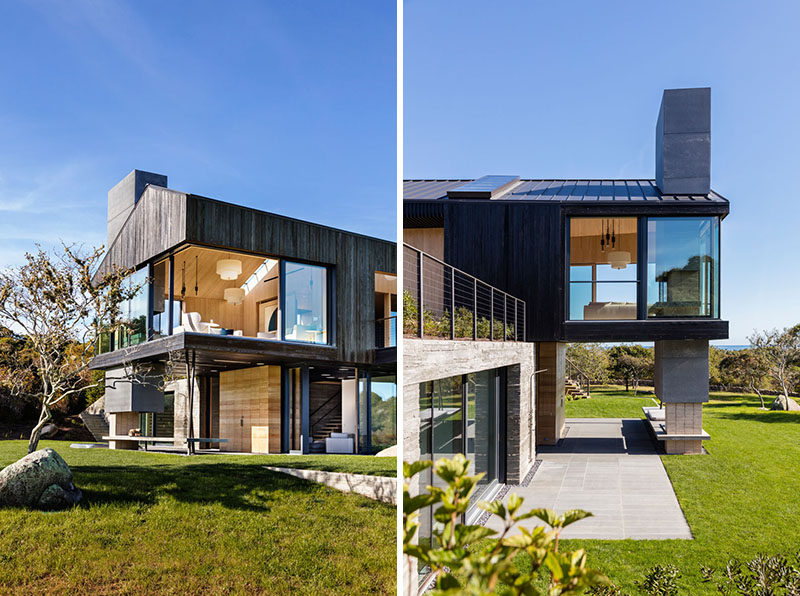 Many of the different areas of this modern house, like the living room upstairs and the bedrooms downstairs, all have floor-to-ceiling sliding glass windows and doors.