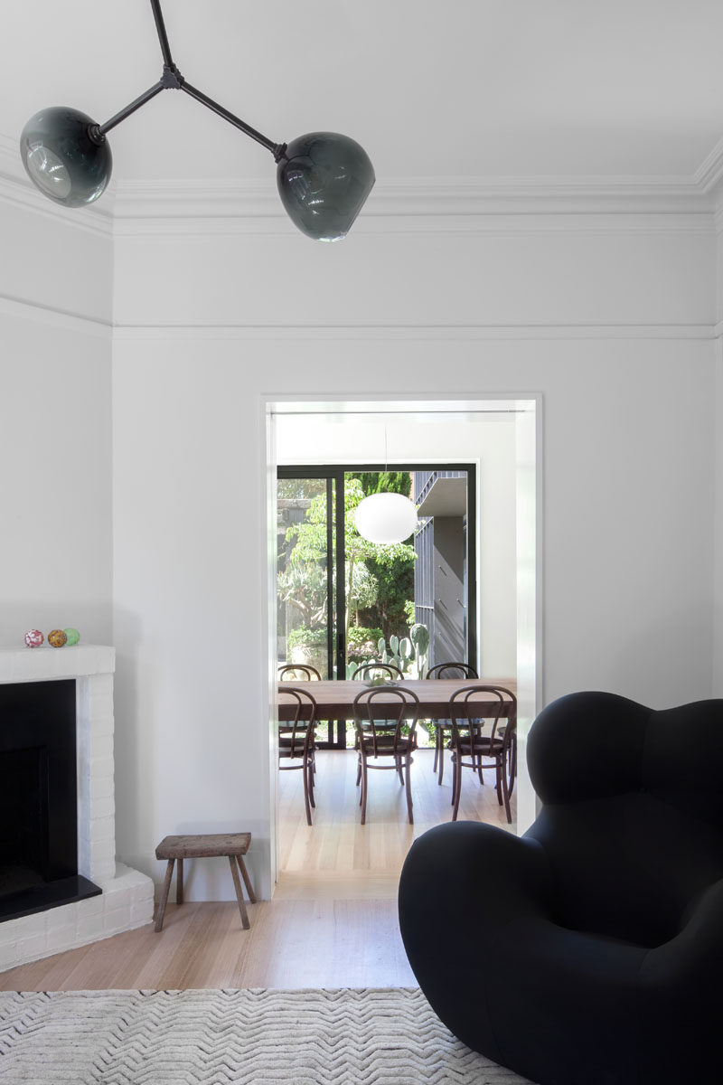 A contemporary grey glass light fixture hangs in a renovated Edwardian cottage.