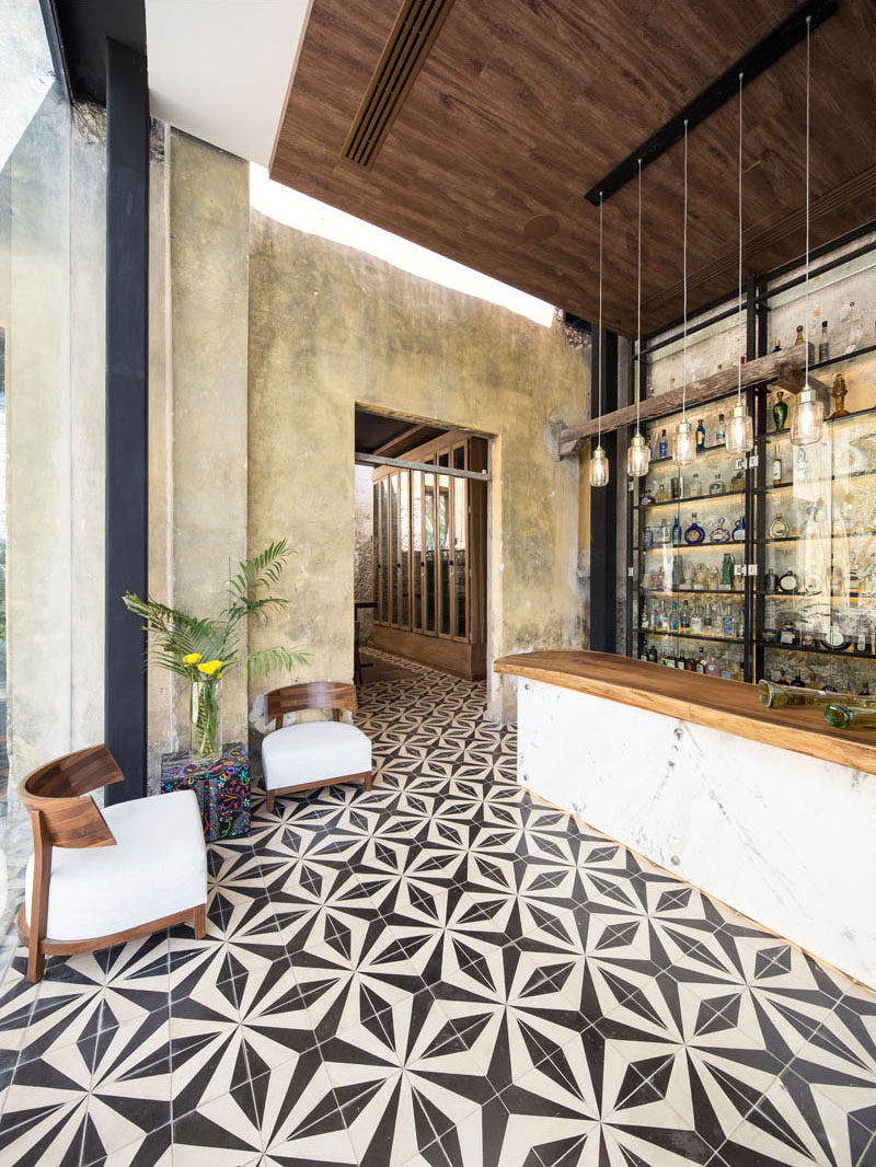 Decorative black and white patterned tiles flow throughout this modern restaurant and add a sense of continuity to the space.