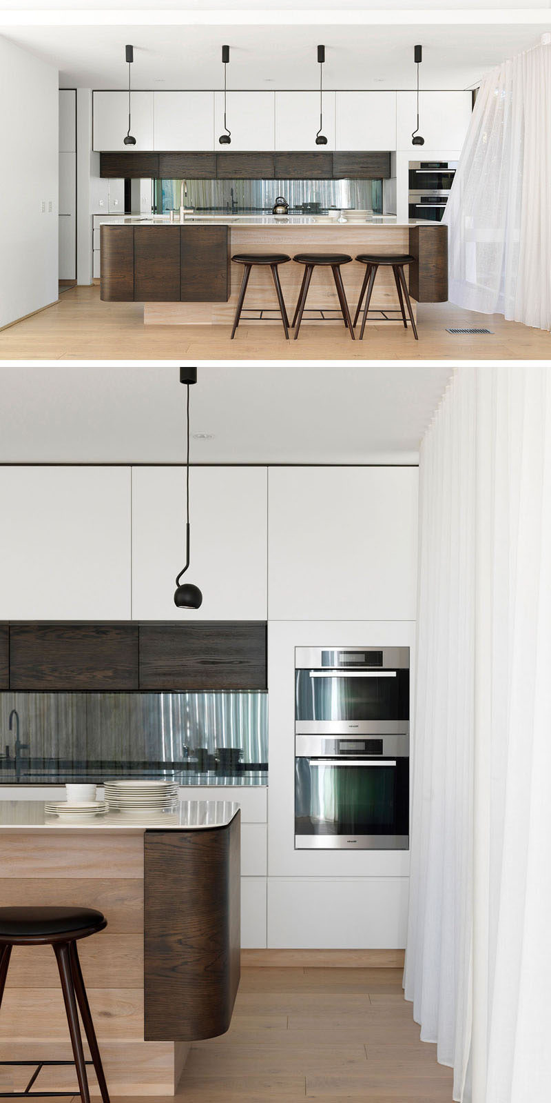 This wood and white modern kitchen has a toughened glass window that doubles as a backsplash. The design of the kitchen island emulates the cantilevered first floor additions seen outside.