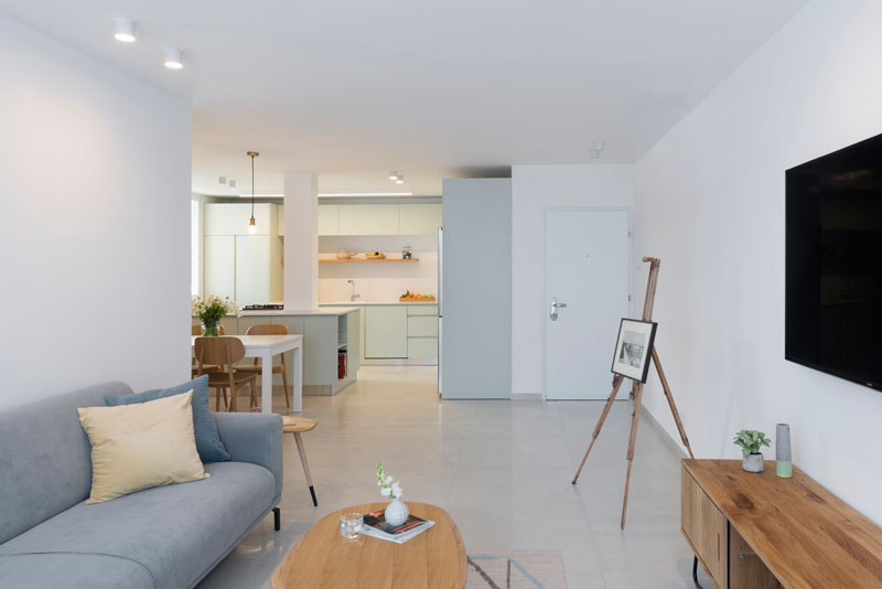 In this modern apartment, an open layout reveals different areas. Smooth light colored flooring continues throughout the home.