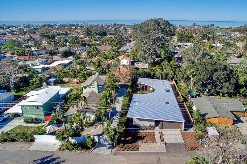 An aerial photo shows just how unique the curved roof of this modern home is.