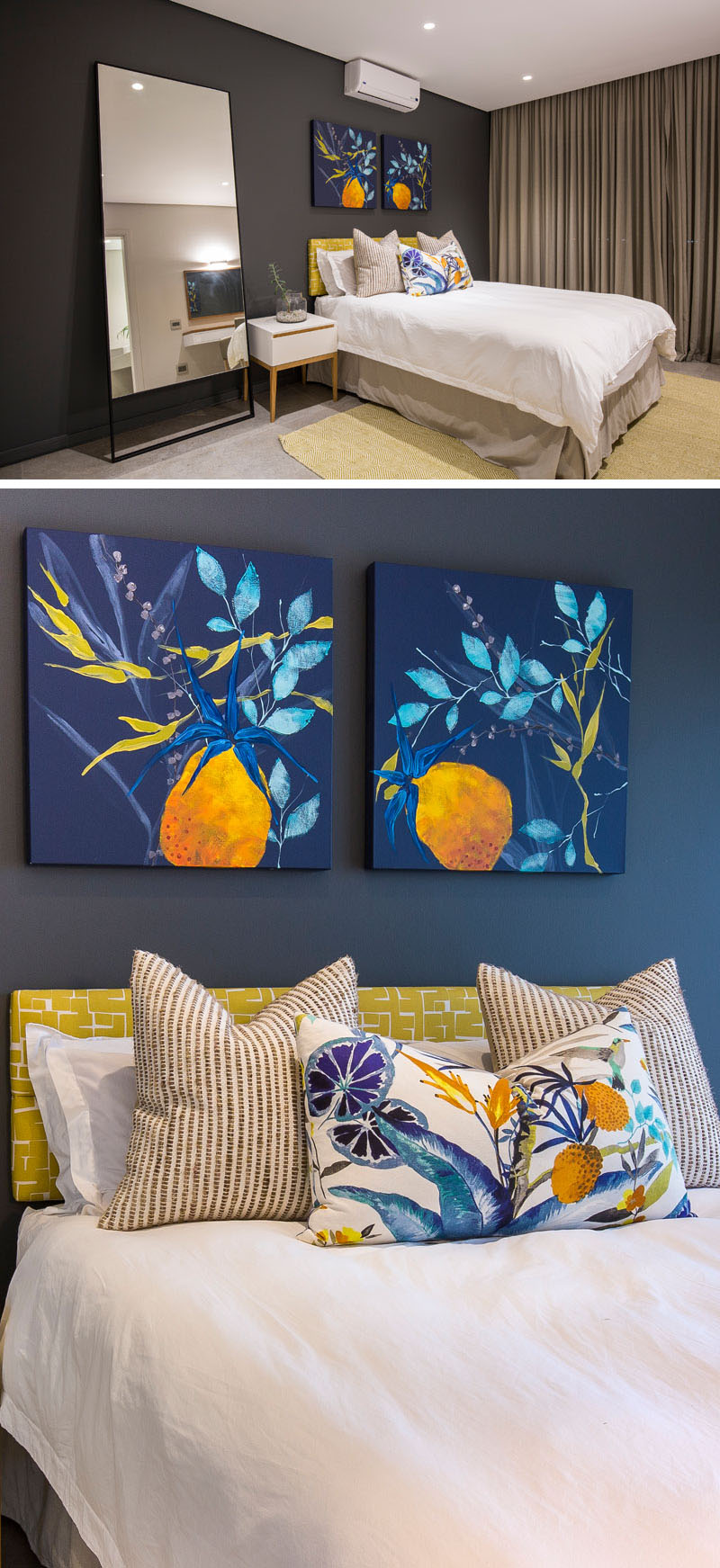 Colorful paintings, bright fabrics on the bed, and the light green headboard stand out against the dark blue accent wall in this modern bedroom. The large mirror beside the bed, reflects the ceiling lights used in this room.