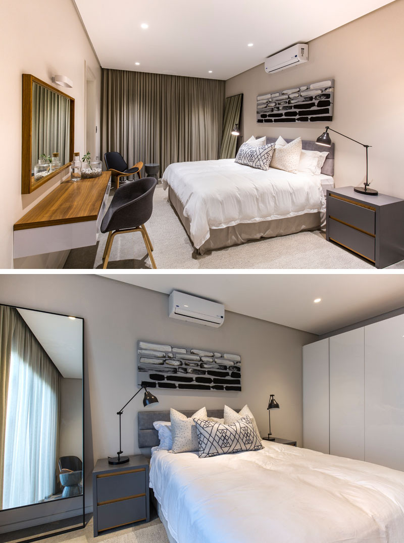 In hues of grey, black, and white, this modern guest bedroom is modern in design. The dark grey bedside tables, and the large light colored wardrobe, provide plenty of storage in this room.