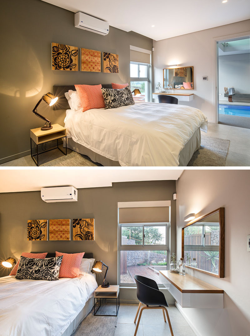 In this modern bedroom, wood bedside tables compliment the mounted art pieces that hang above the bed, while the color in the pieces compliment with the bedding and decor. A window beside the floating desk provides extra lighting in this guest bedroom.