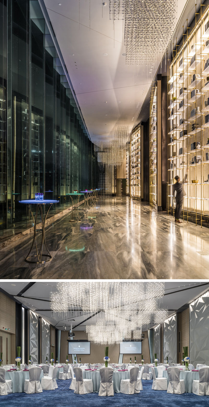 Delicate chandeliers, floor-to-ceiling brass shelves and a wall of glass line the hallway outside of the banquet hall in this modern hotel. Inside the banquet hall, geometric, white textured accent walls and an extremely large chandelier make the space unforgettable.