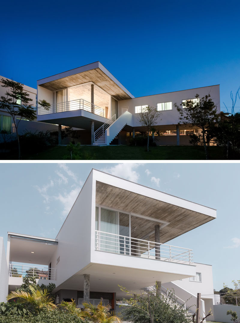 From the backyard of this modern house, it's easy to see that it sits above the ground, creating a void underneath the home..