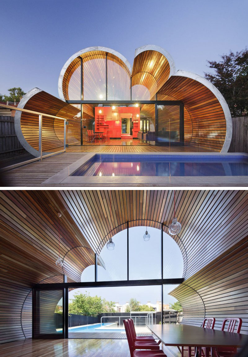  The glass patio doors along with the curved windows of the modern Cloud House, create a floor-to-ceiling view of the backyard. 