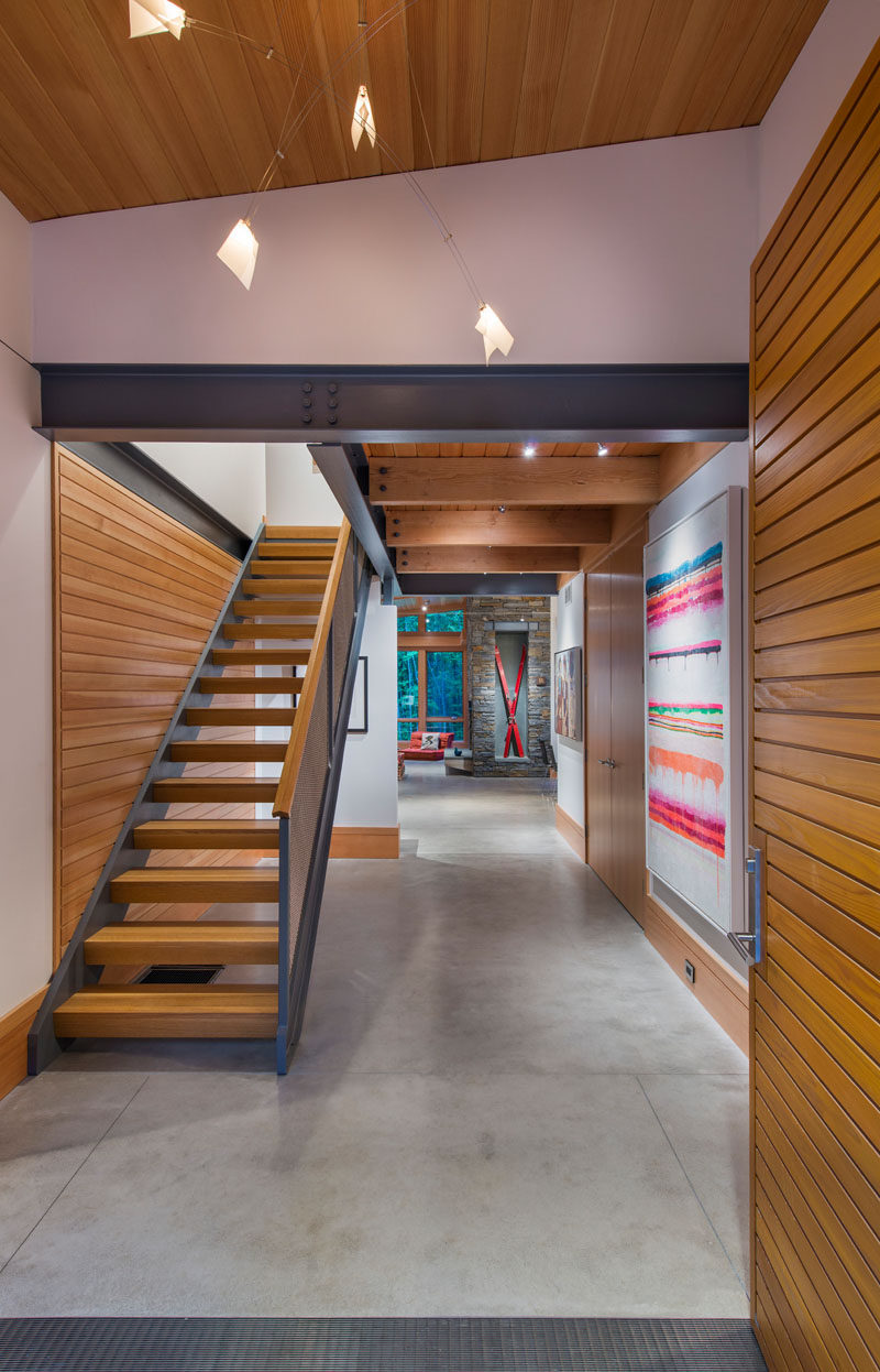 Inside this modern house the material palette has been kept simple, with concrete floors, fir ceilings, wood and metal beams, and plaster walls.