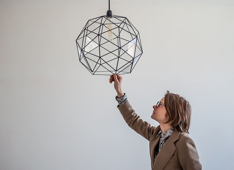 Glass pendant light with black detailing inspired by minimalism and geometry. 