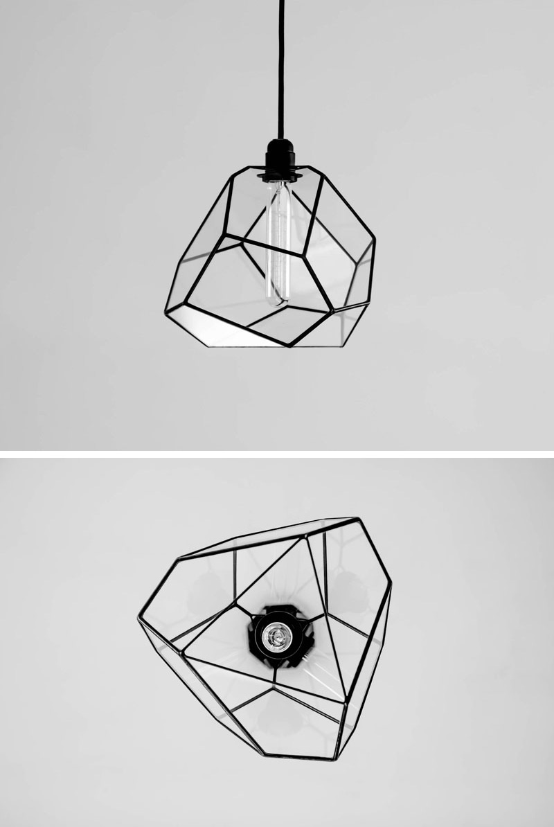 A modern glass pendant light with a geometric shape and black accents. 