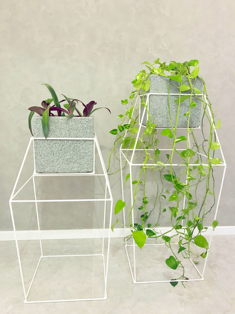 Inspired by diamonds, these modern white metal stands are large, and have extra supports that allow plants to grow and wrap organically around the structure. #PlantStand #ModernPlantStands #Garden #Plants #ModernHomeDecor