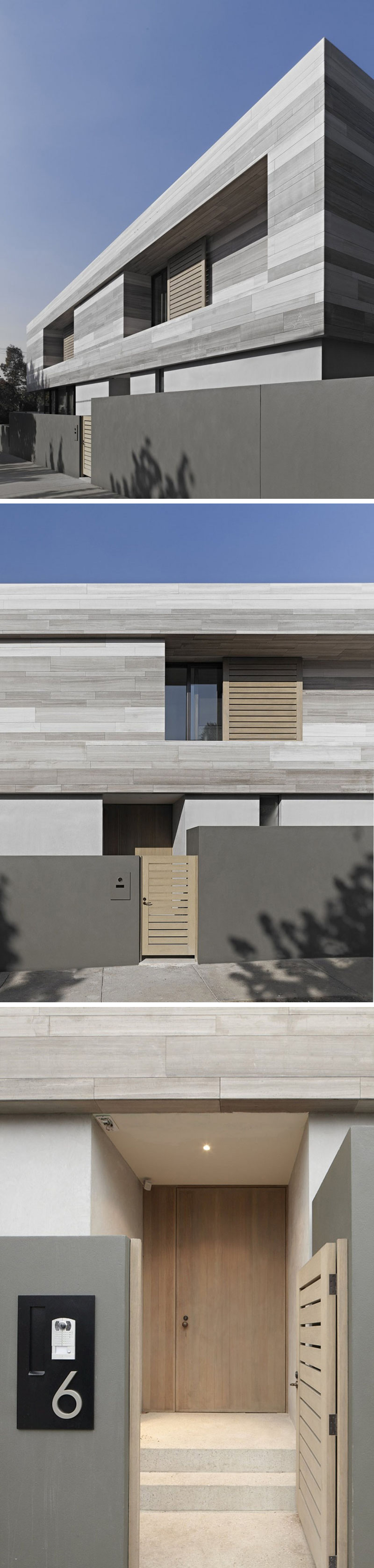 The exterior of this modern home is made from bands of travertine stone, that was collected from opposite sides of a quarry, giving it it's multiple grey tones. A light wood gate leads to the front entrance of the house. 