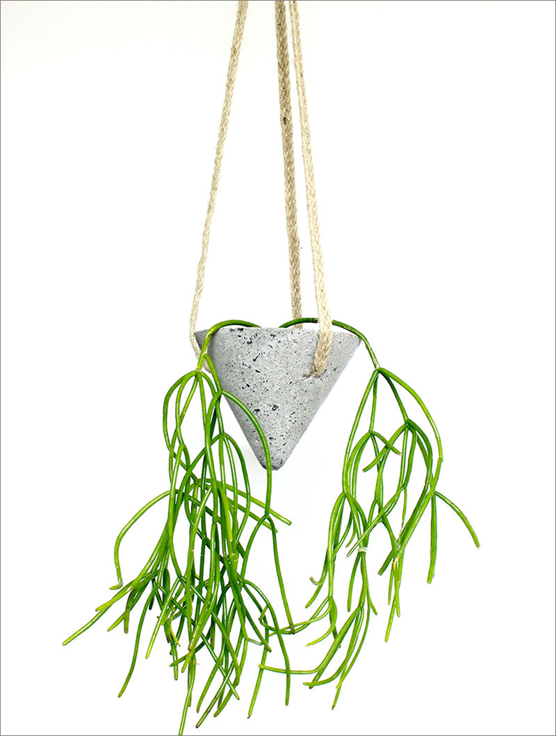 Triangular in shape, this modern concThis cone-shaped concrete planter is hung from rope, and is ideal for when you want to add an industrial touch to any interior.rete planter is hung from rope, perfect for both an industrious work space, and at home.  #HangingPlanter #ModernPlanter #HomeDecor #Garden #Plants