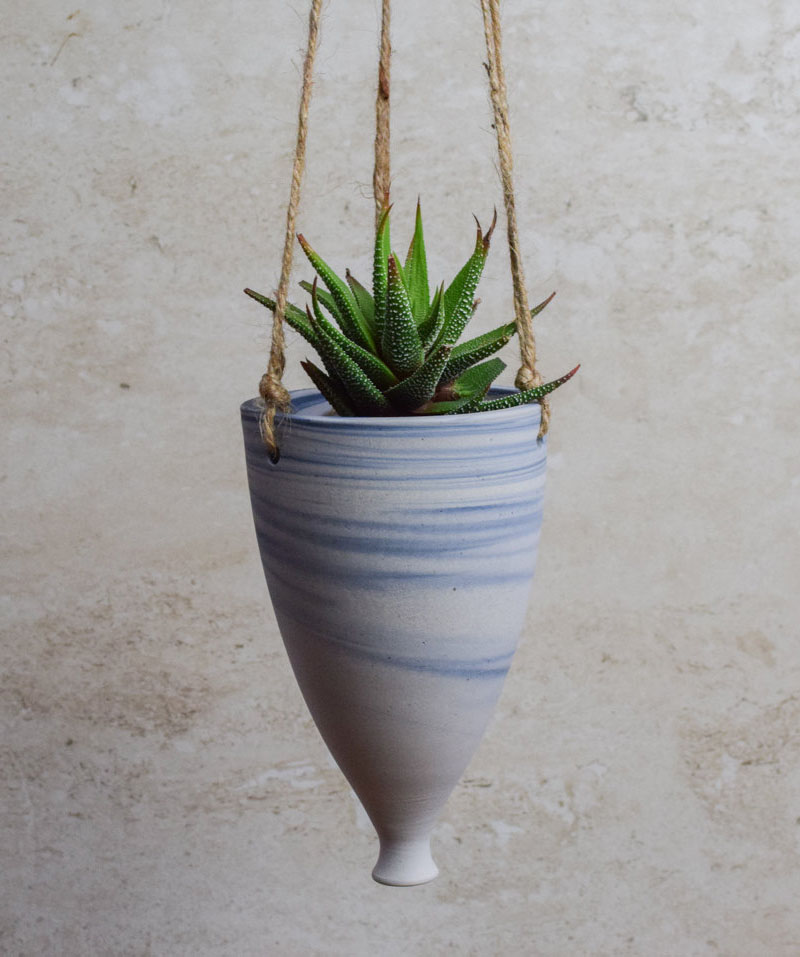 This blue and white ceramic hanging planter has a elongated shape and a marble effect.  #HangingPlanter #ModernPlanter #HomeDecor #Garden #Plants