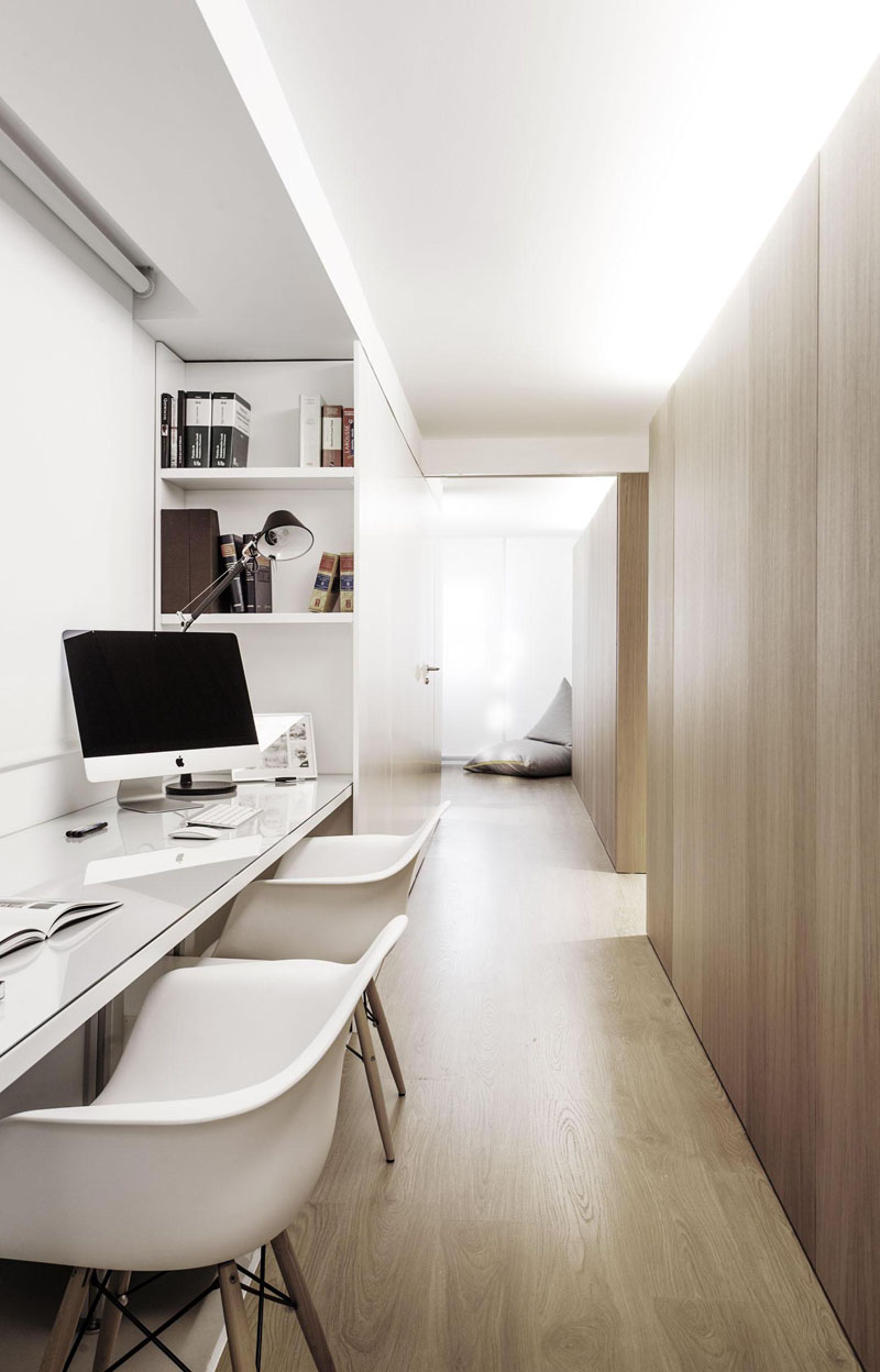 Built-in shelves provide extra storage beside the desk for two in this home office. Soft lighting from above creates a perfect work environment in this space.