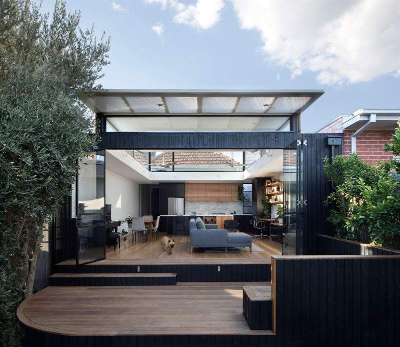 Ben Callery Architects have recently completed a contemporary extension to a brick house in Melbourne, Australia, that's home to a new open plan living space with a home office, dining area and kitchen.