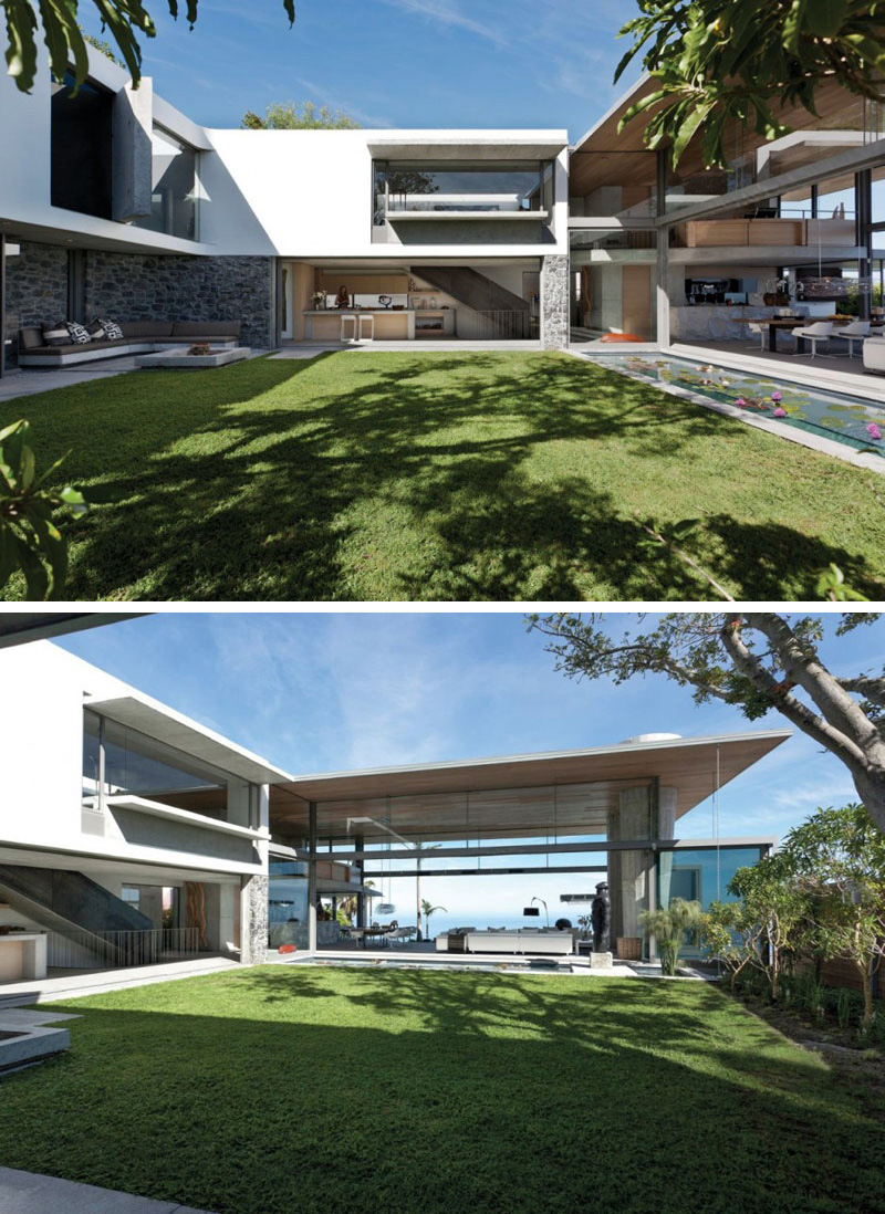  A central grassy courtyard is revealed that can lead into other areas of this modern house. To the side of the courtyard a long water feature is displayed.