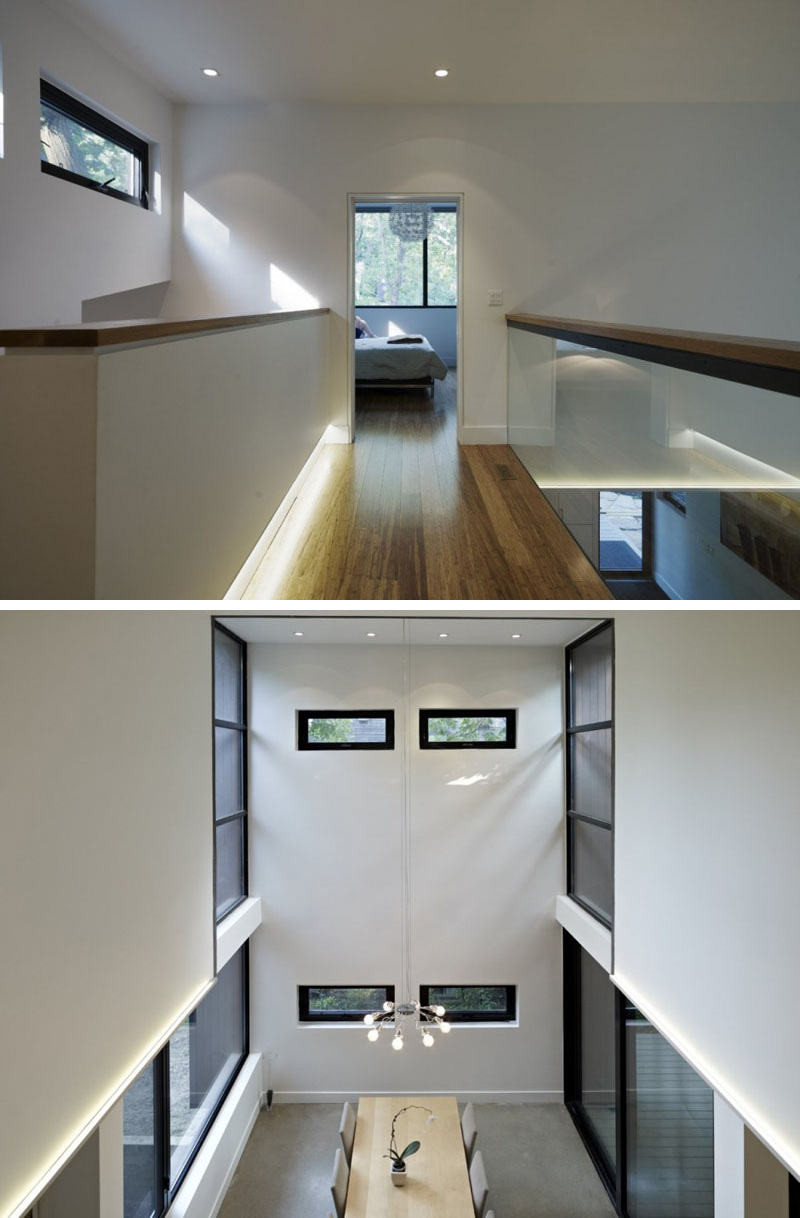 On the top floor a modern wood bridge with a glass safety railing leads to the master bedroom. Looking over the railing, one can see the dining area with the double-height ceiling. 