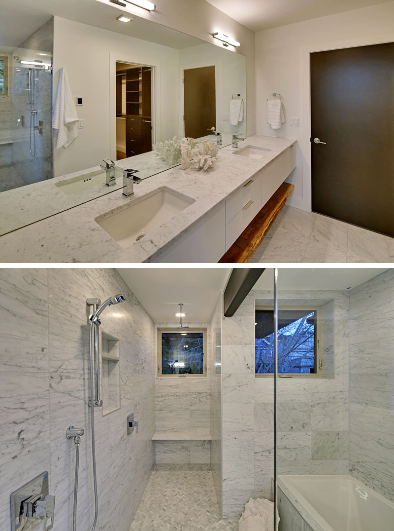 In this modern master bathroom, the counter, shower and bathtub surround are covered in carrara marble. Again, a maple shelf is used below the long counter that has his and her sinks.