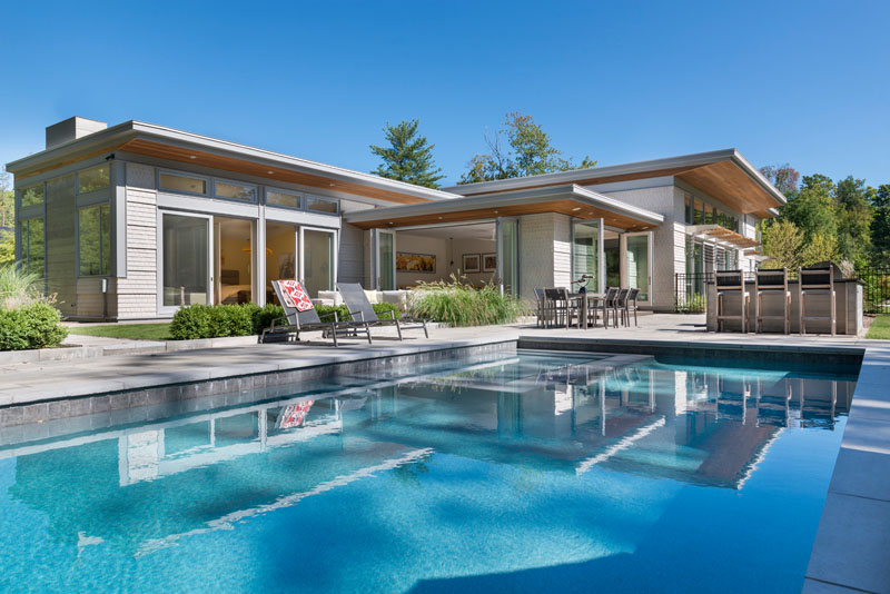 Flavin Architects together with interior design firm Jane Young Design, have completed this contemporary home in Lenox, Massachusetts, that's surrounded by trees.