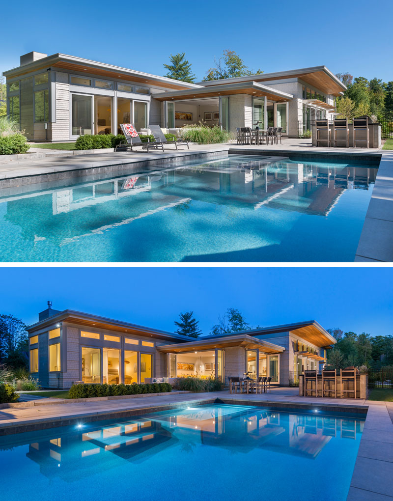 This modern house opens up to a backyard with a swimming pool, outdoor lounge, bar and dining area.