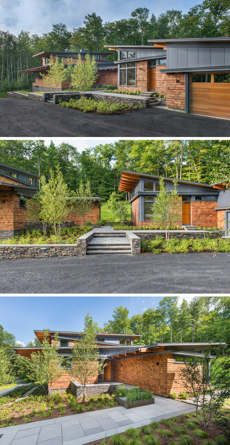 This modern house, which is discreetly set back from the road, is split into two sections, the main house on the left, and the guest house and garage on the right. When approaching the house, you're greeted by modern landscaping and can see through to the woods behind the house.