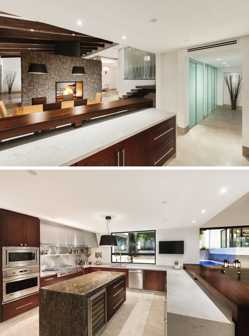 In this modern renovated kitchen, the ceiling height is lower than that of the dining room, so upper cabinets were not installed to provide the space with a feeling of openness. A custom-made stove exhaust was designed to add a touch of industrial and to help reflect the light all over the kitchen, while itauna granite was installed for the countertops to provide durability.