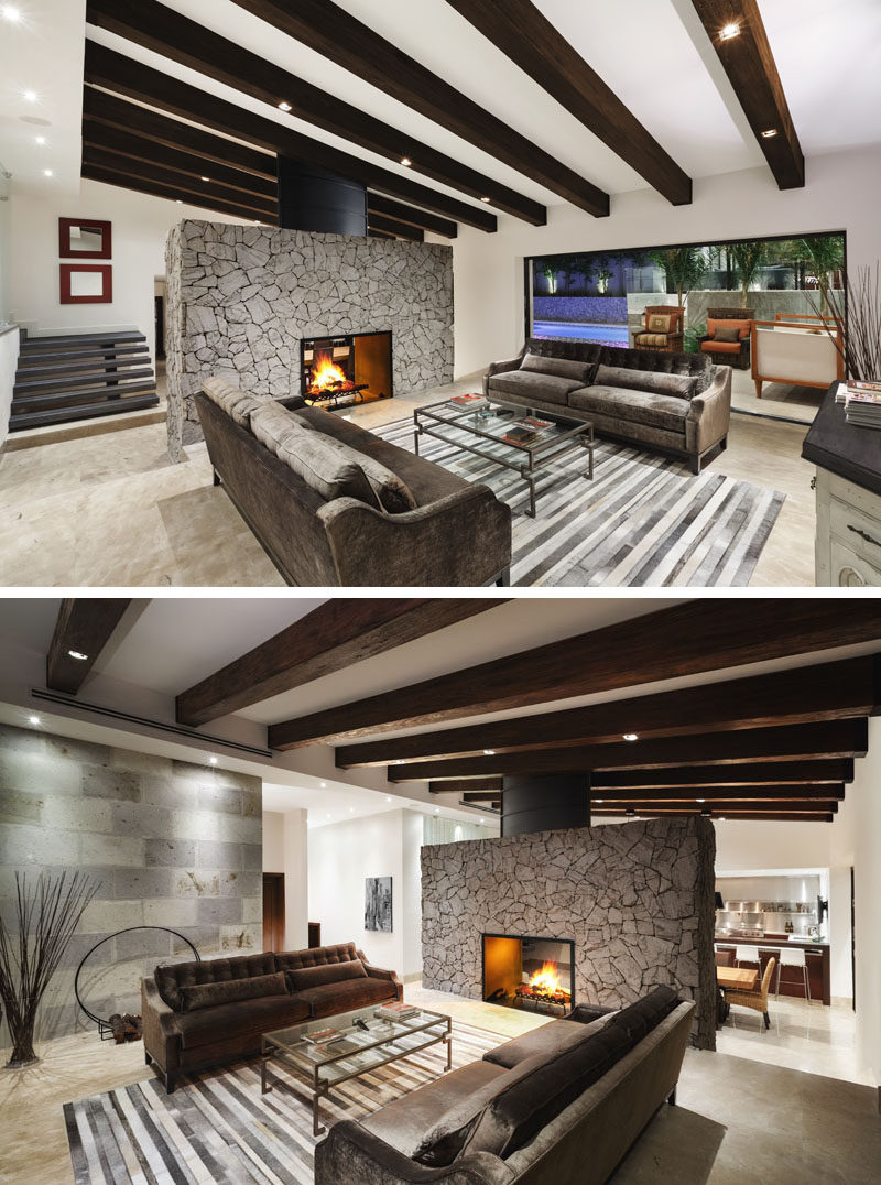 This modern renovated house now features a bright open interior with a large stone fireplace that can be enjoyed from the living room or the dining room. The living room opens up to the terrace outside, and creates an indoor/outdoor living environment, perfect for entertaining. Wood beams were installed to protect the structural integrity of the roof, and to add new lighting.