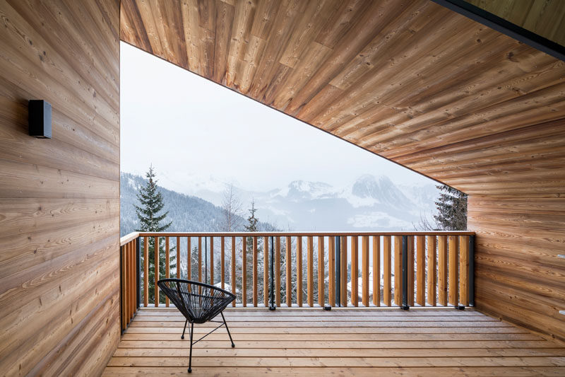 The covered balcony of this mountain house is the perfect place to enjoy the views.