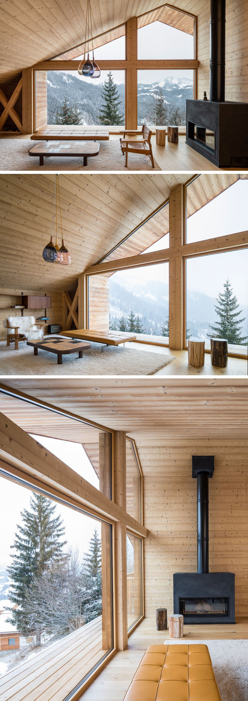 This rustic modern living room features a wall of windows that follow the roof line and frames the picturesque view, while a large black fireplace can be lit to provide warmth to the home in the colder months.